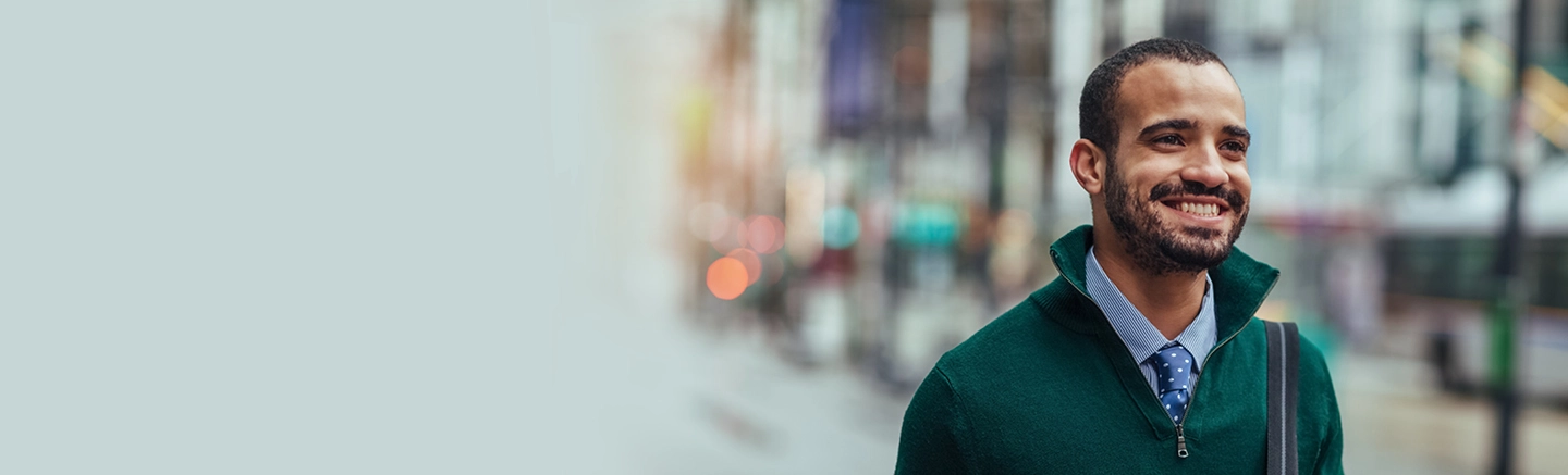 Smiling professional in an urban setting, illustrating Hays permanent recruitment services for hiring high-quality, long-term talent.