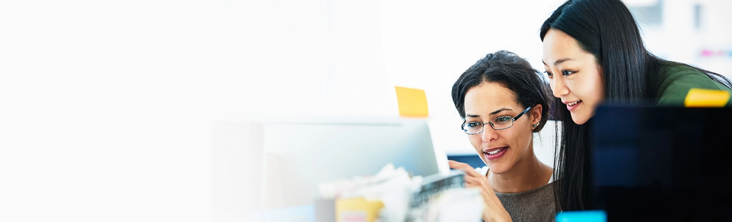 Two professionals collaborating at a computer, on career transition and outplacement support from Hays, helping employees navigate change.