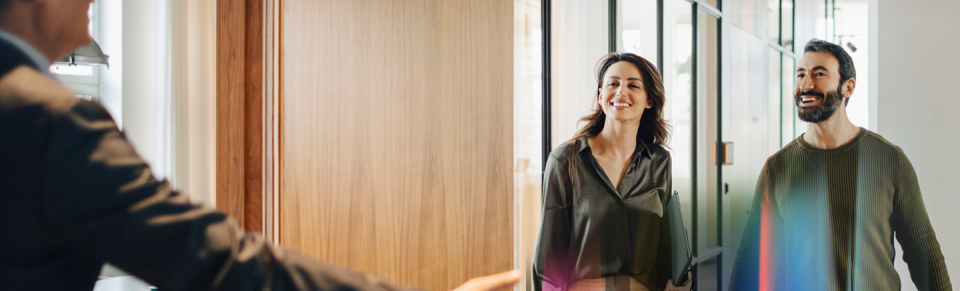 Two professionals walking through a bright modern office, representing fresh career opportunities - Hays Career Hub.